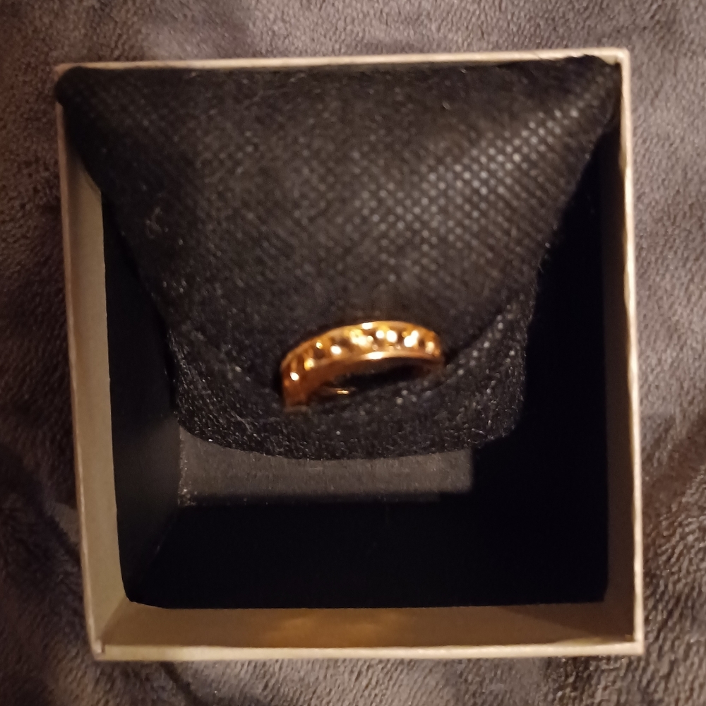 18k gold over 925 Citrine ring. There are 9 round stones. Size 7. Channel set.